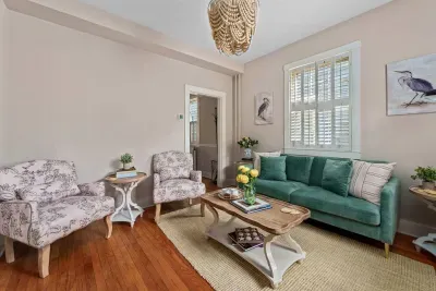 Newly renovated living room with ample seating, 55” smart TV for streaming, and a cozy Historic charm with a professional design touch!