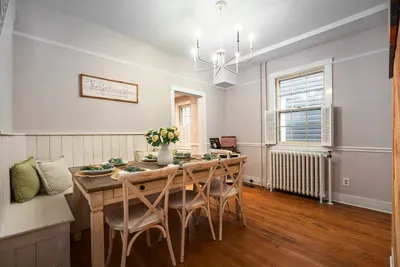 A southern charm dining room with ample seating for 8 including a custom built shiplap bench seat for you and your families ultimate comfort!