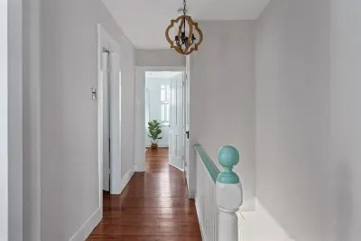 2nd level hallway leading to 3 of the 4 bedrooms and 2 additional full bathrooms.