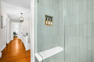Bathroom #2 additional image to show the spacious shower with custom bench seat for convenience!