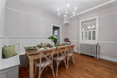 A southern charm dining room with ample seating for 8 including a custom built shiplap bench seat for you and your families ultimate comfort!