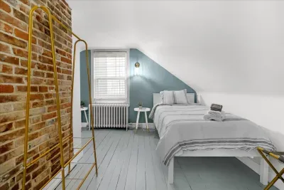 3rd level attic bedroom additional image to show the clothes hanging rack, luggage rack, etc.