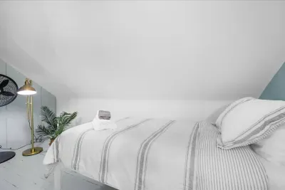 3rd level attic bedroom to show the stand-up fan, and one of the comfortable twin foam mattresses!