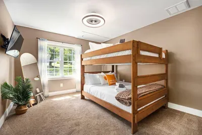 Bedroom #3 equipped with two Queen bunkbeds, a ceiling fan, 43" smart TV, full length mirror, etc.