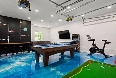 Game room with life jackets for all ages, a regulation sized pool table, 75" smart TV, and reclining couches where you can catch your favorite sporting events!