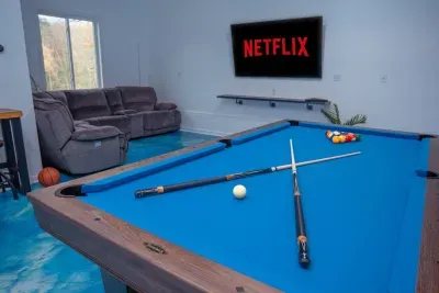 Enjoy time with friends and family in our game room equipped with a 75" TV, regulation size pool table, full bathroom, and reclining couches!