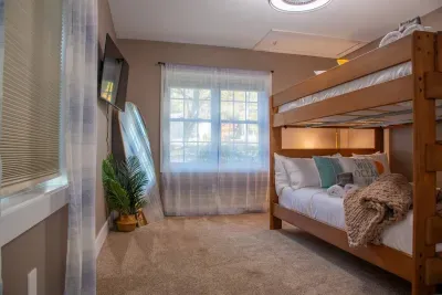 Bedroom #3 equipped with two Queen bunkbeds, a ceiling fan, 43" smart TV, full length mirror, etc.