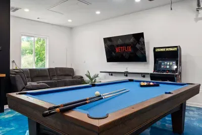 Enjoy time with friends and family in our game room equipped with a 75" TV, regulation size pool table, full bathroom, and reclining couches!