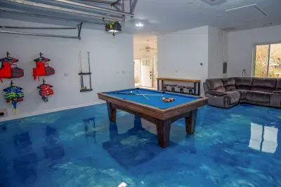 Game room with life jackets for all ages, a regulation sized pool table, 75" smart TV, and reclining couches where you can catch your favorite sporting events!