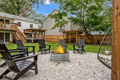 8-person fire pit equipped with 6 Adirondack chairs and 2 hanging egg chairs for your ultimate comfort by the fire!