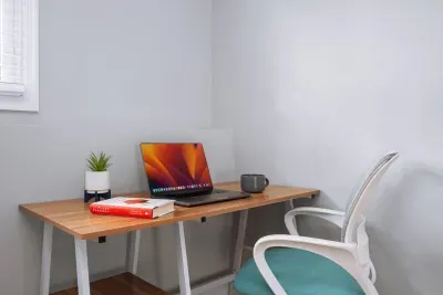 Downstairs remote workstation with desk and chair with outlets for power connection to your own personal computer, tablet, etc.