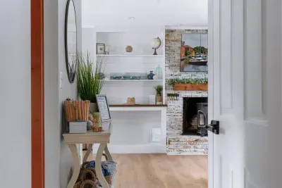 A view from the upstairs bedroom hallway looking into the living room.