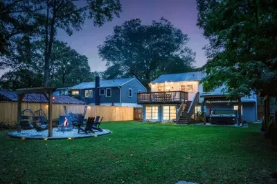 Twilight shot of the large, fully fenced backyard.