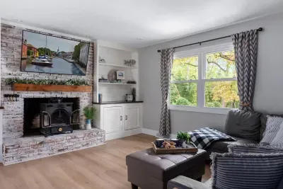 Upstairs living room with a 55" smart TV, plenty of seating for the whole family, and a wood burning fireplace