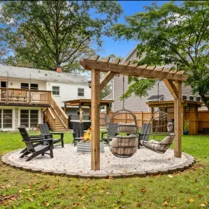 Hanging egg chairs at fire pit area, grill pergola, and covered hot tub!