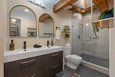 Primary ensuite bathroom, double sinks, shower with skylight