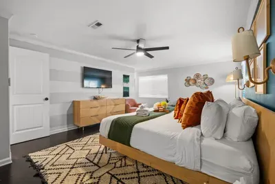 Primary suite with smart TV and ceiling fan
