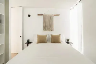 Behind the living space is a large den complete with Queen bed, two nightstands, and large closet. Keep the linen divider open for a large studio feel, or close if off and utilize the separate hall door to access the den space for more privacy.