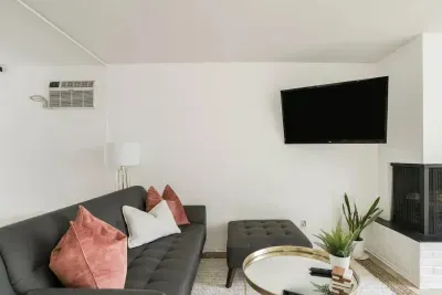 Living space has wall unit AC and Roku TV.