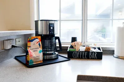 Coffee Bar with regular and decaf coffee, tea, sugars and creamers. Togo cups for those morning strolls to the beach.