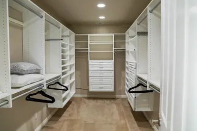 Primary bedroom walk in closet