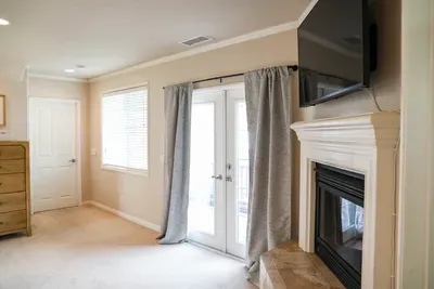 Primary Suite w/ gas fireplace and flat screen TV