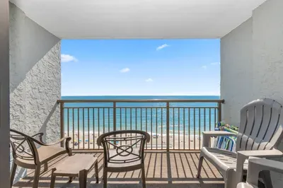 Private oceanfront balcony with beach views and relaxing outdoor seating