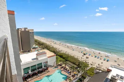 Sweeping oceanfront views with sandy beach access and a resort-style pool