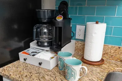 Convenient coffee station with drip brewer, pod machine, and stylish mugs