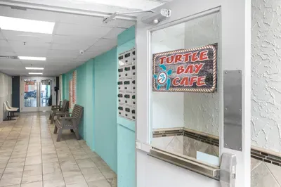 Bright coastal-style hallway with seating and convenient on-site cafe access