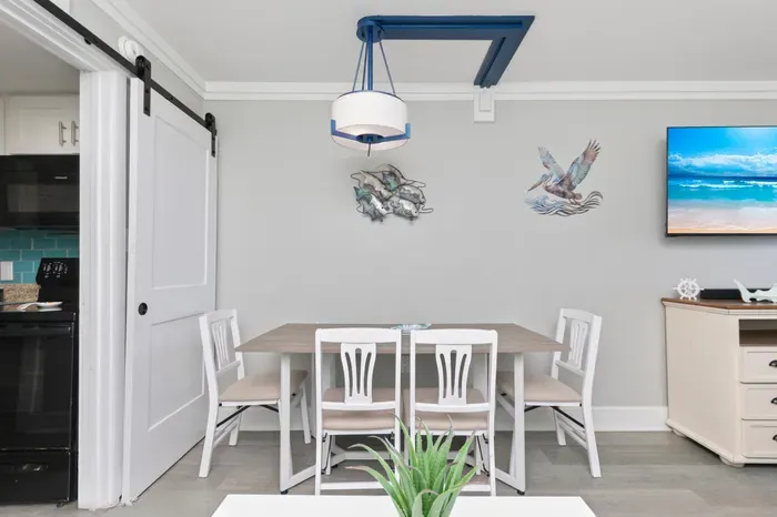 Bright coastal dining space with stylish décor and seating for four