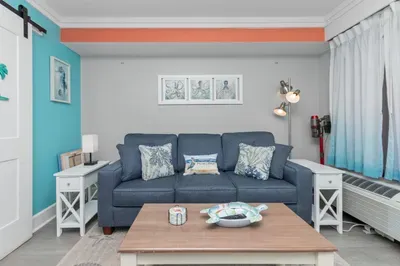 Bright coastal-style lounge with comfy sofa and airy beach-house charm