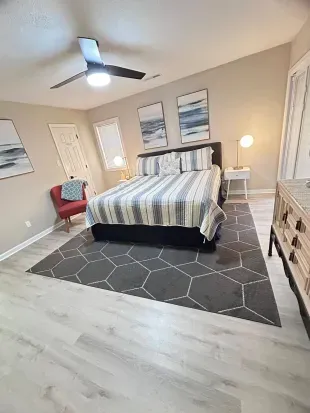 Bright, stylish bedroom with coastal decor and plenty of space