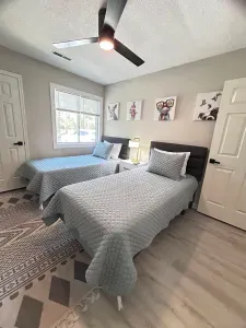Bright twin bedroom with natural light, modern style, and cozy comfort