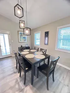 Bright modern dining area with seating for 6 and stylish pendant lighting