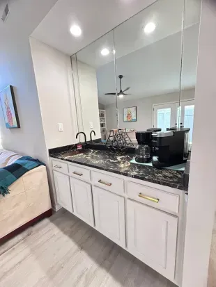 Chic coffee bar with mirrored backsplash and elegant marble-style counter