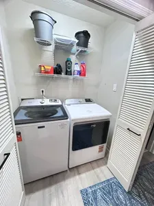 Convenient in-unit washer/dryer with organized storage shelves
