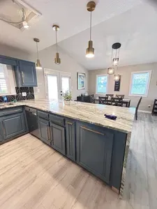 Bright modern kitchen with large island, vaulted ceilings, and dining space