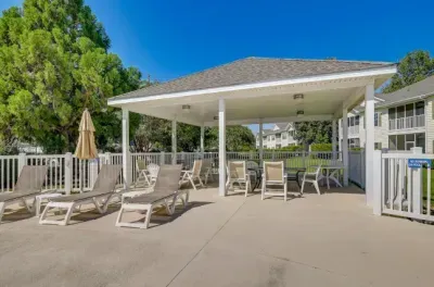 Poolside pavilion with loungers, shade, and tables—perfect to unwind.