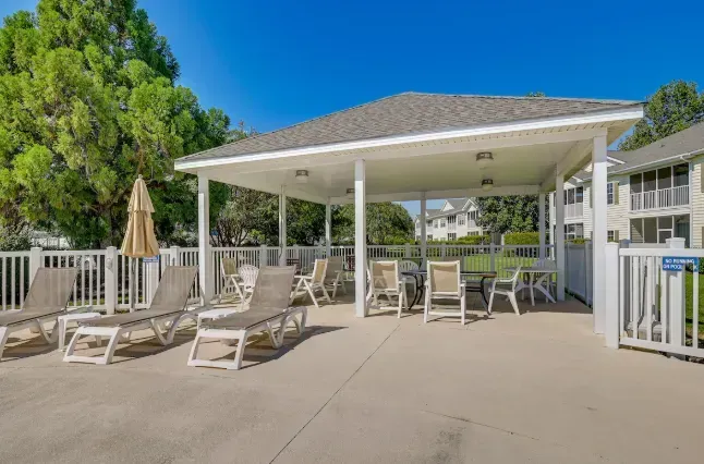 Poolside pavilion with loungers, shade, and tables—perfect to unwind.