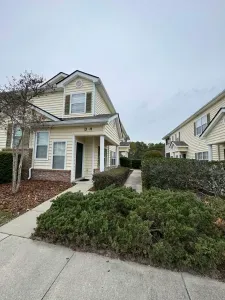 Charming end-unit townhome with tidy paths and lush landscaping.