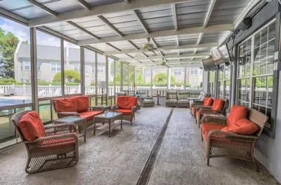 Large screened-in porch with TV, fans and comfy poolside seating