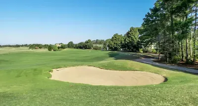 Fairway-front retreat with sweeping golf course views and blue skies