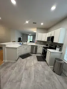 Bright open kitchen with stainless appliances, breakfast bar, and ample prep space