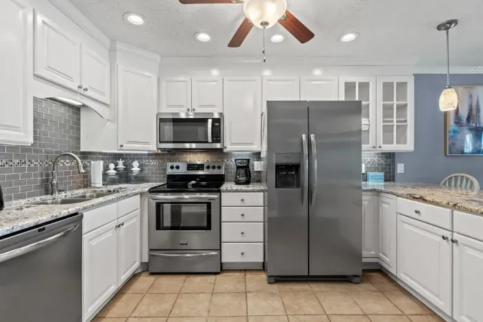 Bright modern kitchen with granite counters and stainless steel appliances