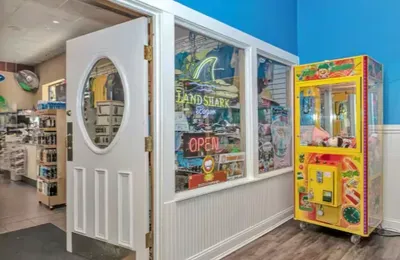 Fun game room vibe with claw machine and colorful, lively common area
