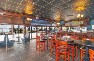 Spacious beachfront bar with water views and casual dining atmosphere