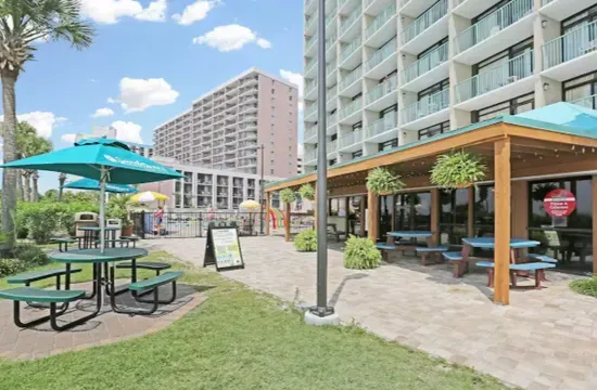 Resort-style outdoor lounge with shaded seating and family-friendly amenities