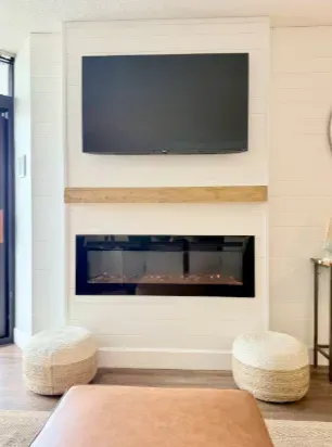 Modern fireplace lounge with mounted TV and cozy designer touches