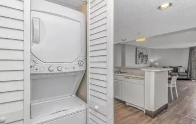 In-unit washer/dryer with open-concept kitchen and living area